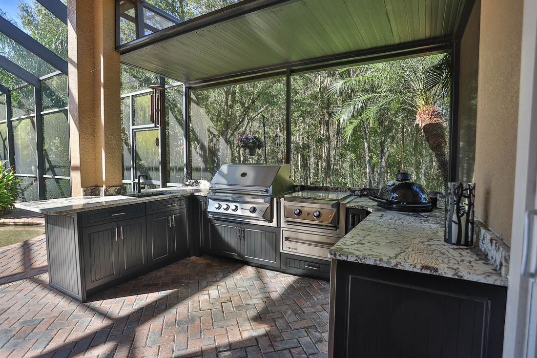 Grill and smoker in outdoor kitchen space